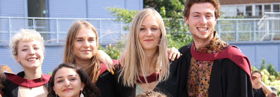 Students in their gowns posing for a photo at graduation